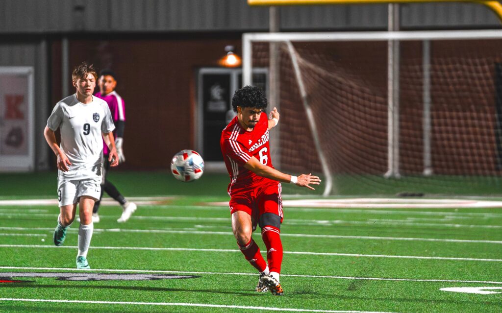 Kilgore High School senior Leo Yzaguirre sends a ball sailing to a teammate in a recent game. Yzaguirre and the Bulldogs, unbeaten and leading the District 15-4A standings, are home against Carthage Friday, starting at 5 p.m. with the junior varsity game. Read the story for all the area's soccer schedule this weekend. (Photo by ALEX NABOR - ETBLITZ.COM)