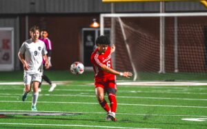 Kilgore High School senior Leo Yzaguirre sends a ball sailing to a teammate in a recent game. Yzaguirre and the Bulldogs, unbeaten and leading the District 15-4A standings, are home against Carthage Friday, starting at 5 p.m. with the junior varsity game. Read the story for all the area's soccer schedule this weekend. (Photo by ALEX NABOR - ETBLITZ.COM)