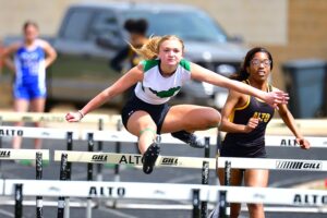 Overton's Kaylee Stevens (foreground) putting away the competition in the 100 meter hurdles. Stevens had the high total for the Overton girls in the district meet at Alto. Overton's girls won the meet as a team, and several are moving on to area, and Overton's boys were second in the meet, also sending quite a few to area. (Photo by RONNIE SARTORS of SPORT SHOT PHOTOGRAPHY - ETBLITZ.COM)