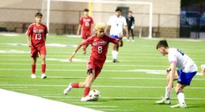 Kilgore's Jordy Velasquez (8) pushes the ball upfield against Lindale, in last Thursday's second-round playoff win. Kilgore (22-2-2) faces Jacksonville (22-4-1) Tuesday night in Henderson, a 7:30 p.m. start, with the winner taking a spot in the UIL Region II Tournament this weekend in Tyler. (Photo by DENNIS JACOBS - ETBLITZ.COM)