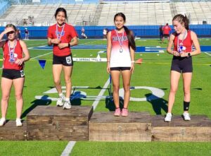 Henderson's Giselle Alejandro (second from left) and Kilgore's Ruby Almanza (third from left) took gold and silver, respectively, in the mile run on Thursday at the 17-18-4A Area Meet at Spring Hill High School in Longview. They'll advance to the regional meet next weekend in Bullard, where a top-two finish would send them to the UIL State Track & Field Championships in Austin the first weekend in May. (Photo courtesy of KILGORE HIGH SCHOOL TRACK & FIELD - T.J. GILLEN-HALL)