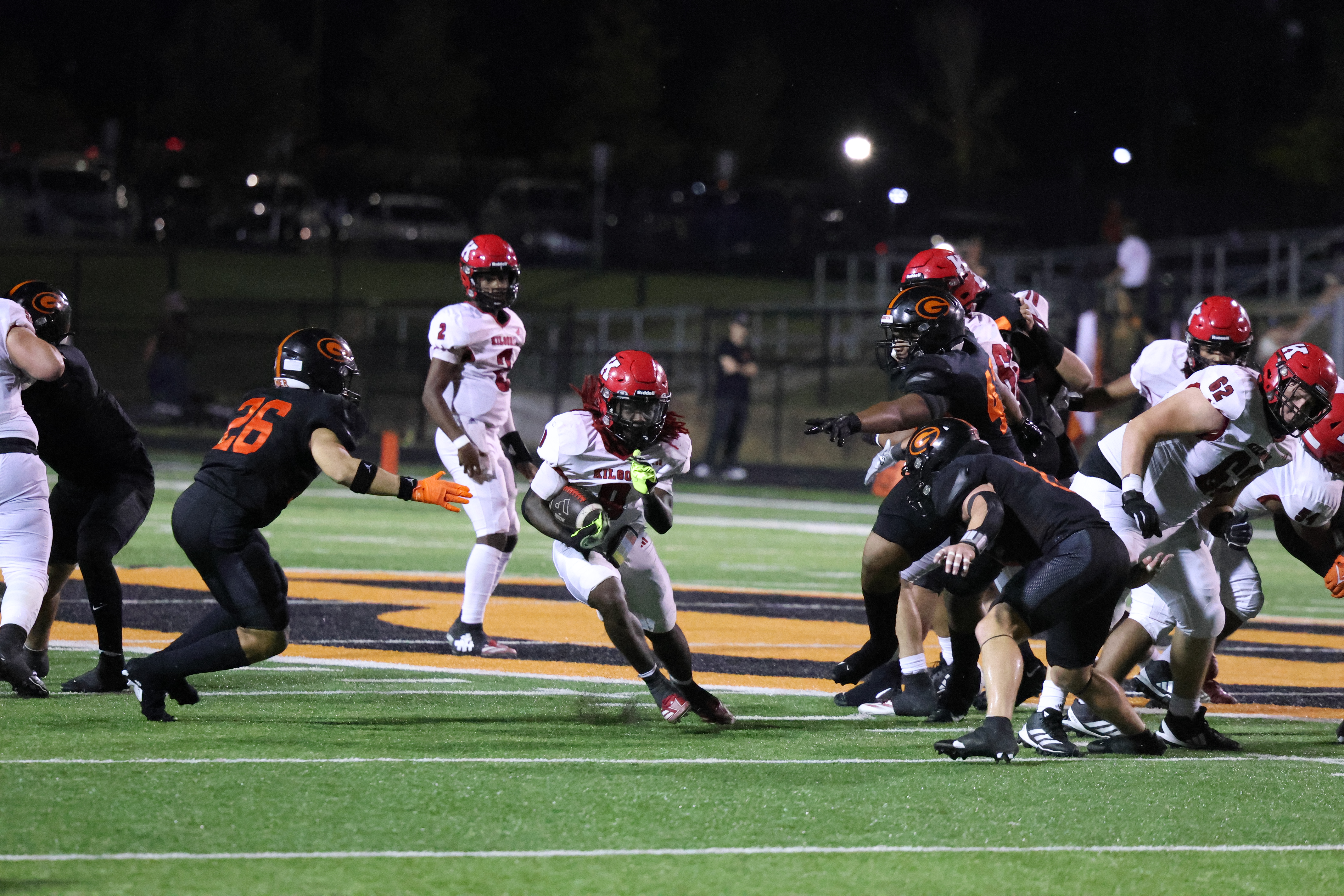 Kilgore High School running back Rayshaun Williams (8, center) runs through a gaping hole in Gilmer's "Black Flag" defense Friday night at Jeff Traylor Stadium in Gilmer. In a shootout that came down to the final seconds, it was the Buckeyes that wound up pulling out a 24-22 win. But not without some controversy: another KHS back, Isaiah Watters, went down with 20 seconds left on the clock, and the clock was allowed to keep running until officials finally blew the play dead with six seconds left. Officials called for a 10-second run-off -- there was less than 10 seconds left on the game clock, which meant the game was over. But if Watters was down with 20 seconds left, wouldn't there have been time left on the clock for Kilgore to run another play, even with the 10-second run-off? (Photo by DENNIS JACOBS - ETBLITZ.COM)