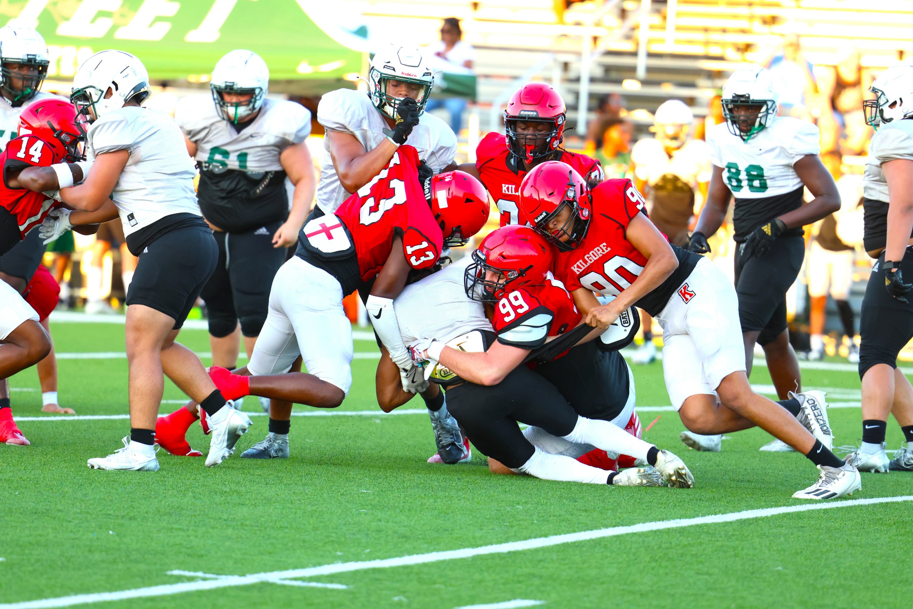 Members of Kilgore's defense swarm onto a Mesquite Poteet ball-carrier during a preseason scrimmage Friday night at R.E. St. John Memorial Stadium in Kilgore. The Bulldogs shut out Poteet, 21-0, and will visit Center in a final scrimmage on Thursday. Kilgore will open the 2024 season at Carthage on Friday, Aug. 30. (Photo by DENNIS JACOBS - ETBLITZ.COM)