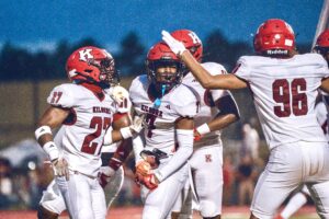 From left: Kilgore's Travis Holmes (27), Ja'Kalen Sheffield (7), and Bi'Syn Williams (96) celebrate a big play in the first half of Kilgore's eventual 20-15 win at Carthage last Friday, Aug. 30. For that win, the Kilgore Bulldogs have been named the first-ever ETBlitz.com Team of the Week, an award that will continue throughout the 2024-25 school year. (Photo by ALEX NABOR - ETBLITZ.COM)