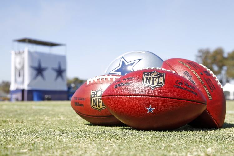 COWBOYS CAMP-FOOTBALLS