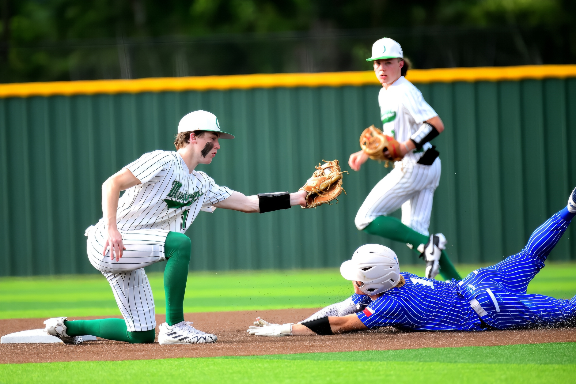 Overton's Mason Rowe attempts to make a tag on a pick-off play against Frankston. The University Interscholastic League made a dynamic change to most team sports besides football on Tuesday. The UIL's legislative council voted to add divisions for each classification, meaning a "big" division and a "small" division for each sport, Division I and Division II. In other words, like football, there will be a Division I baseball champion for 3A and a Division II baseball champ for 3A. And this will take effect immediately, beginning in the upcoming school year. (Photo by RONNIE SARTORS - SPORT SHOT PHOTOGRAPHY - ETBLITZ.COM)