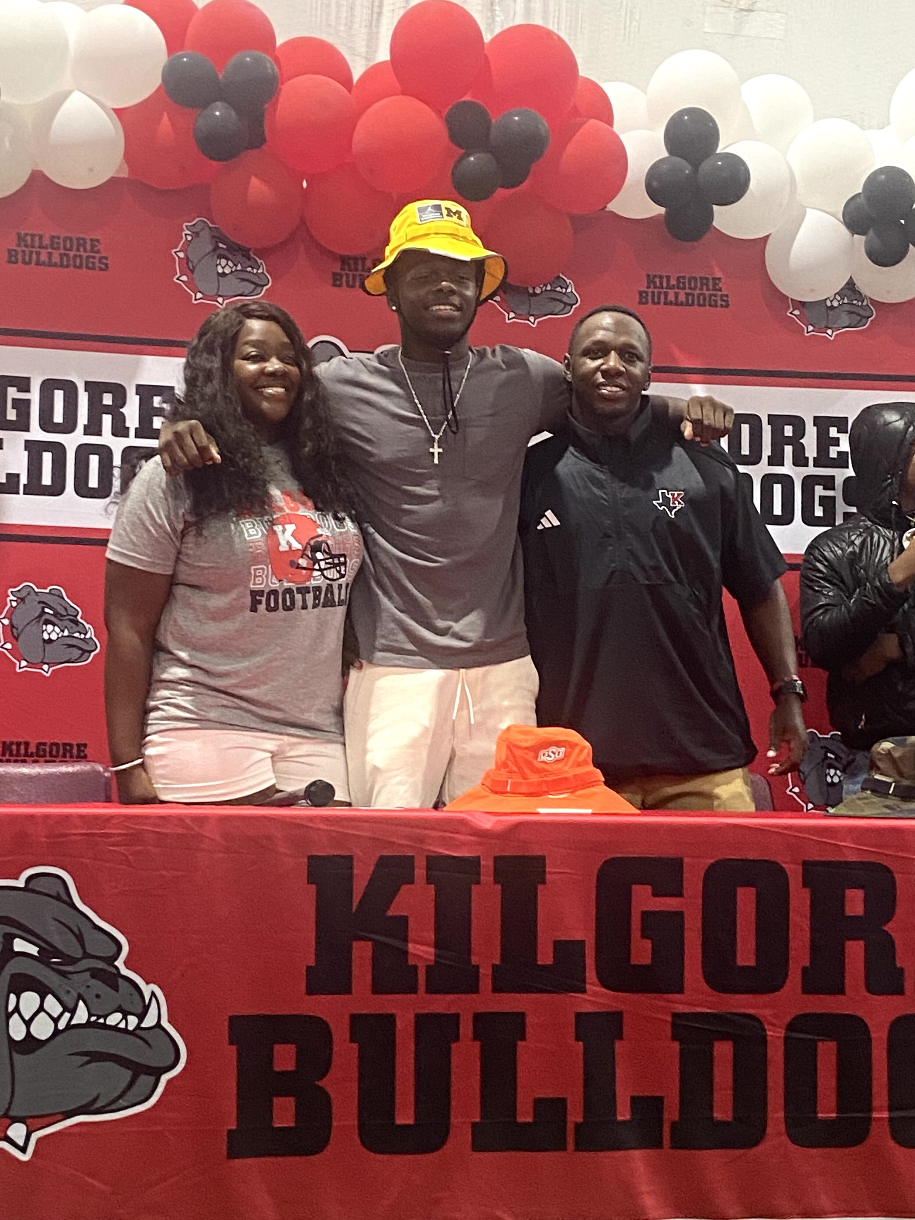 Jayden Sanders (center), with his parents Whitney Clark and Nick Sanders. Jayden committed verbally to the University of Michigan last Saturday. (Photo by MITCH LUCAS - ETBLITZ.COM)