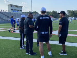 Kilgore College head football coach Willie Gooden (foreground, second from left) talks with officials and members of the Monterrey Tech coaching staff about 90 minutes before kickoff of the game Saturday between KC and Tech at R.E. St. John Memorial Stadium in Kilgore. Gooden's Rangers are ranked No. 4 in the NJCAA national poll, and have won the Southwest Junior College Football Conference championship two years running. (Photo by MITCH LUCAS - ETBLITZ.COM)