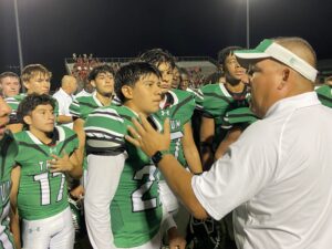 Members of the Tatum Eagles listen as coach Whitney Keeling speaks following the school's 29-14 win over Winnsboro -- a game that was only a half on Thursday night at Tatum ISD Eagle Stadium. A lightning delay caused the game to be delayed for over two hours until it finally began about 9:15 p.m. Thursday. (Photo by MITCH LUCAS - ETBLITZ.COM)