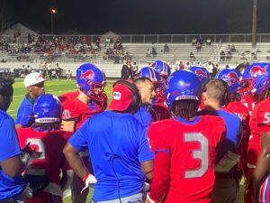 The Henderson Lions, led by coach Clay Baker (center), are in Commerce tonight to face Gainesville (0-3). Henderson is 2-1, and three points away from being undefeated. (Photo by MITCH LUCAS - ETBLITZ.COM)