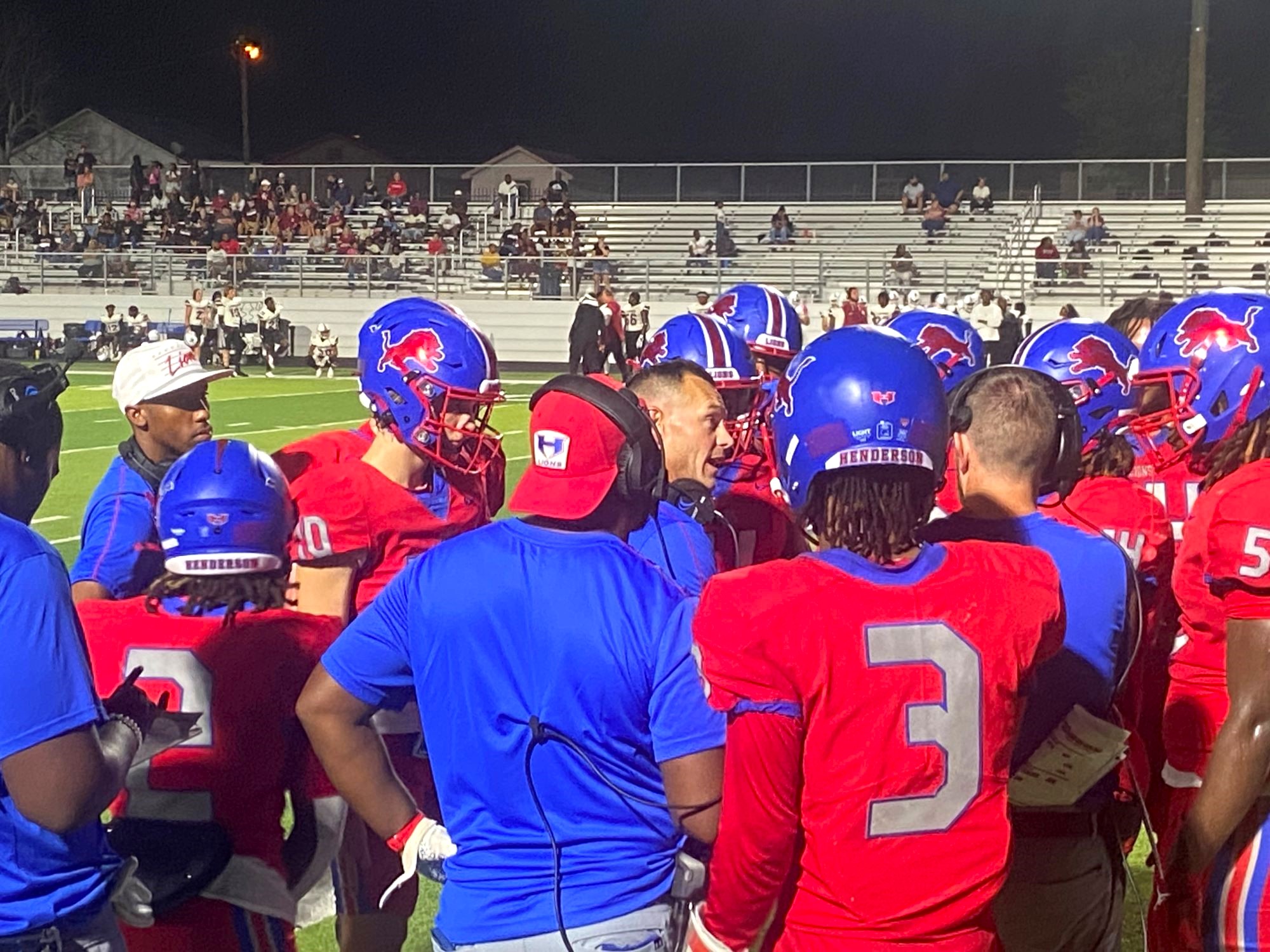 Henderson coach Clay Baker (center) talks to his team and coaches during a time out late in the first half Friday night in their homecoming game against Liberty-Eylau. Henderson would go on to lose the game, a close one, 44-14. (Photo by MITCH LUCAS - ETBLITZ.COM)