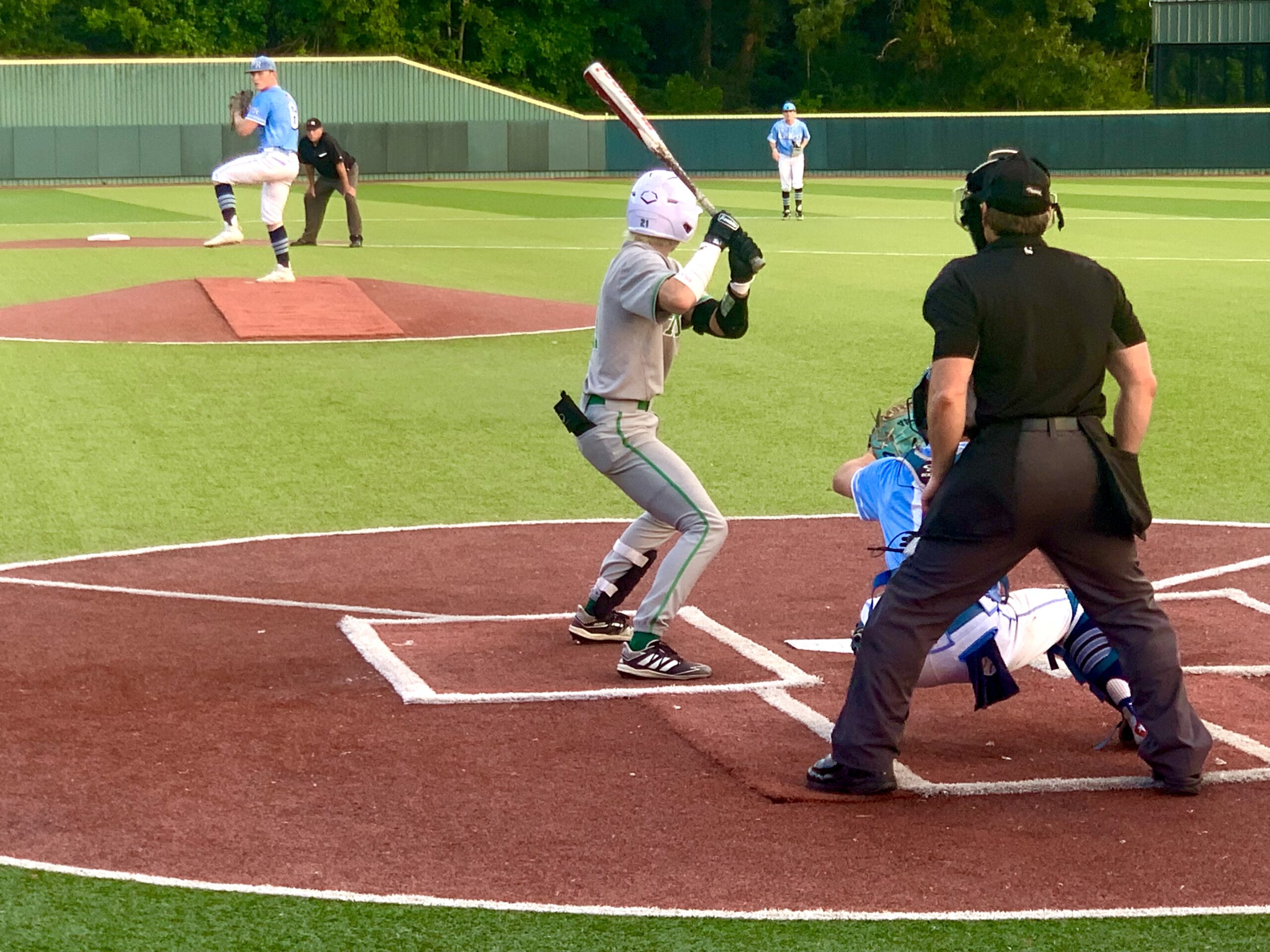 Tatum shortstop Cooper Whiteus (center) steps into the batters box in Rusk, against West Rusk pitcher Cole Jackson, who's in his windup here. Jackson had a fairly good night on the mound, but Whiteus had three hits and scored twice, and teammate Carson Gonzalez only allowed the Raiders two hits in a 6-1 Tatum win. It was game one of a best-of-three series in the UIL Class 3A Regional Quarterfinals, the third round of the UIL baseball playoffs. Game two is Friday night in Bullard at Brook Hill School at 7 p.m., and if West Rusk wins that one, game three would be Saturday at noon, also at Brook Hill. (Photo by MITCH LUCAS - ETBLITZ.COM)