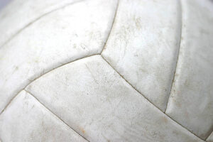 A close up of a used volleyball.