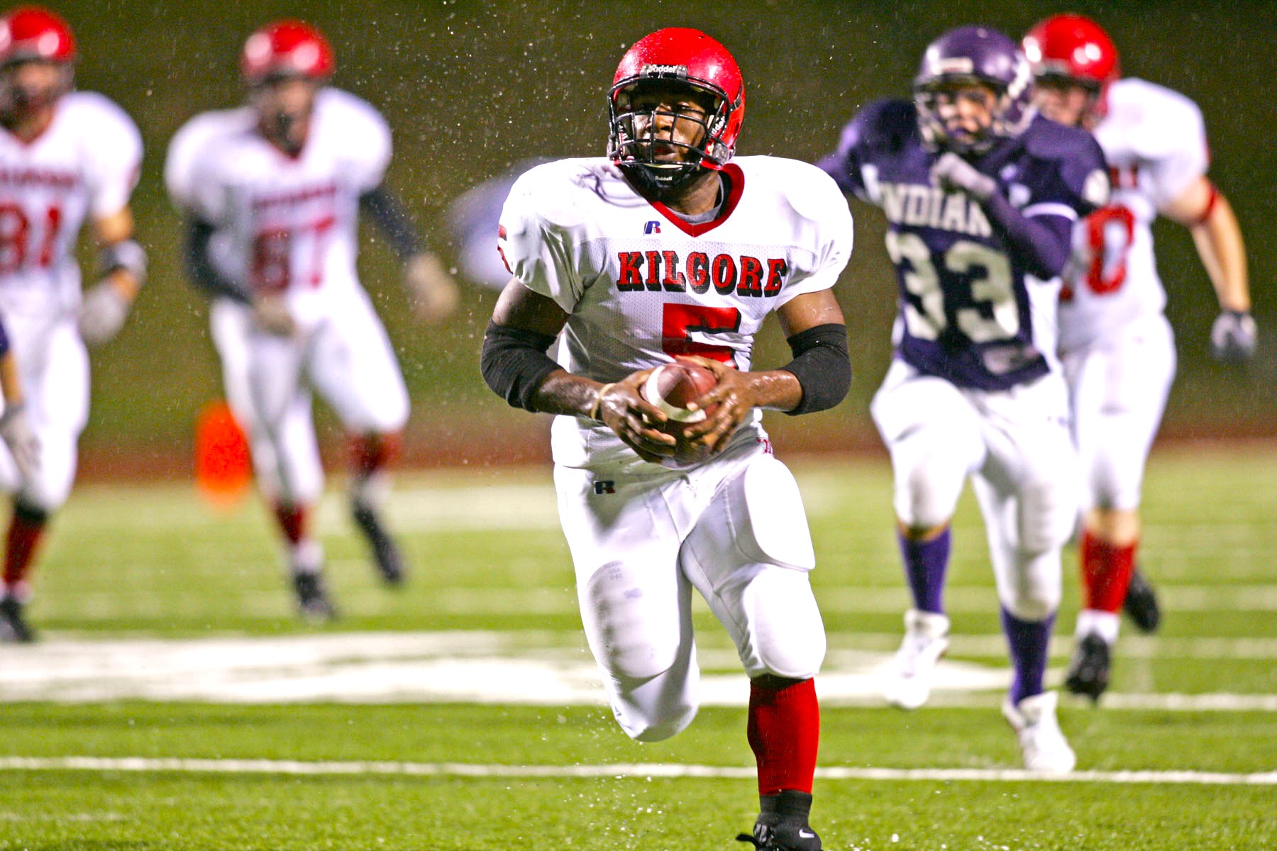 In a scene from the ages, former Kilgore High School running back Keith Gilliam (5) outruns everybody to the end zone in a game against Port Neches-Groves, a legendary playoff game at Stephen F. Austin that occurred in the middle of the night after a series of thunderstorms. Kilgore would go on to finish the season 16-0, winning the UIL Class 4A, Division II state championship. There's a special reunion planned on Sept. 20. You're invited. (Photo by KATHY BOWDEN)